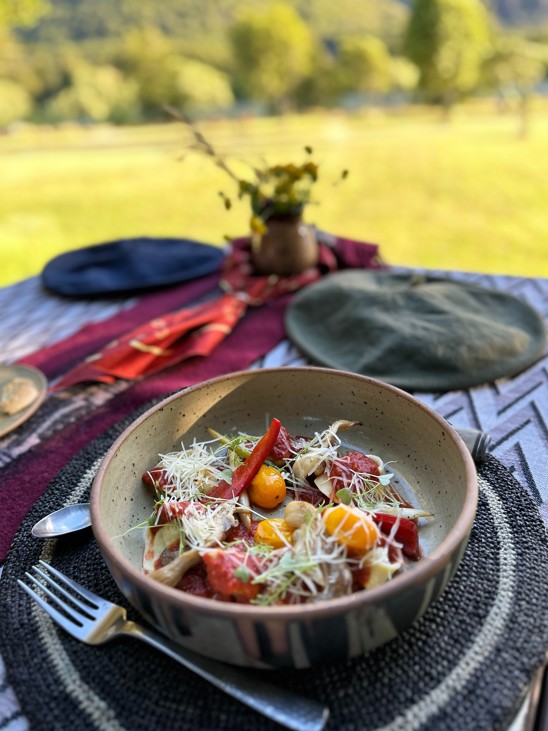 A fresh meal plated on a table outdoors.